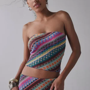 Woman wearing colorful zigzag embroidered knit tube top and matching midi skirt