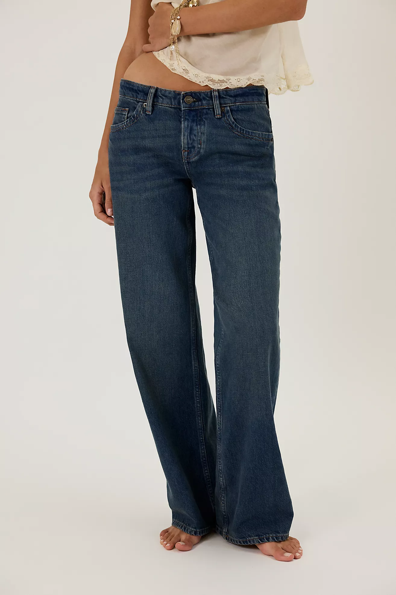 Close-up of low-rise boyfriend jeans with brown belt